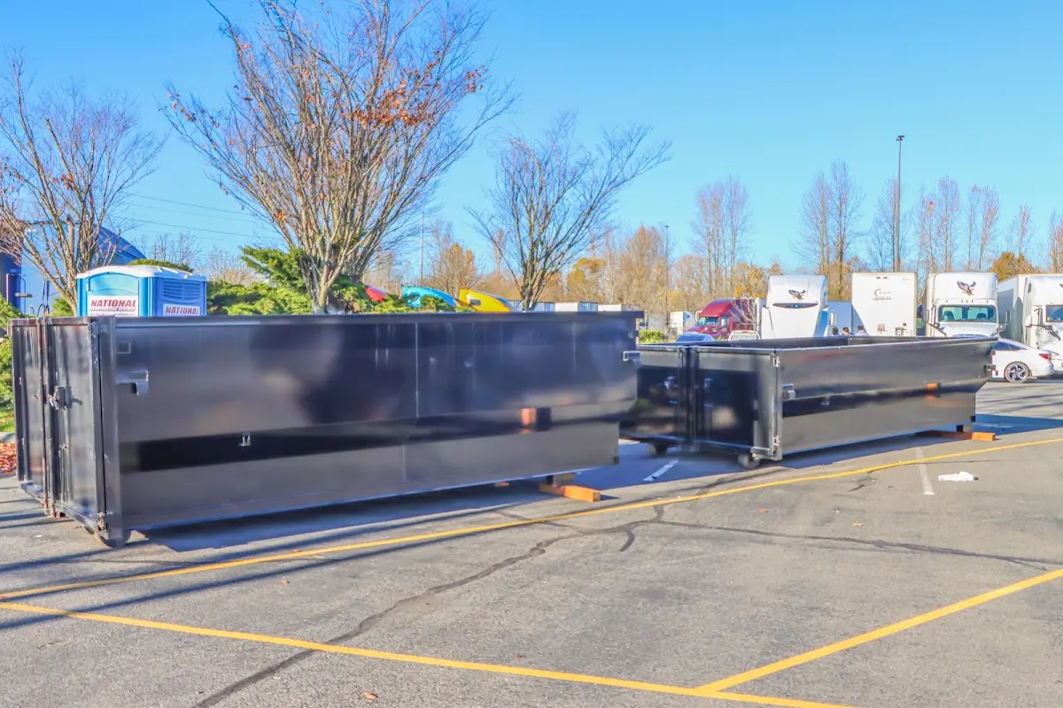 Professional dumpster rental service with roll-off container on residential driveway in Punta Gorda